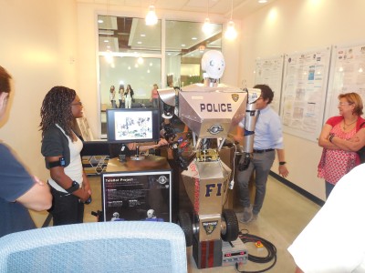 Students examine the initial prototype of the TeleBot created in FIU's Discovery Lab. 
