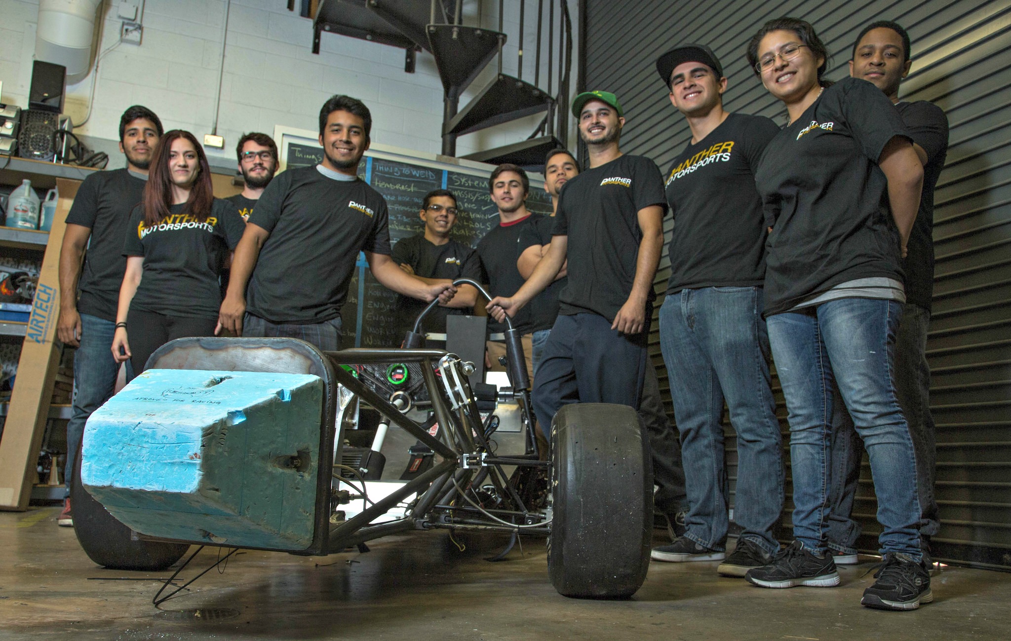The FIU-SAE team with their nearly completed race car, which they will be taking up to Michigan in May for the 2015 Formula SAE Michigan competition.