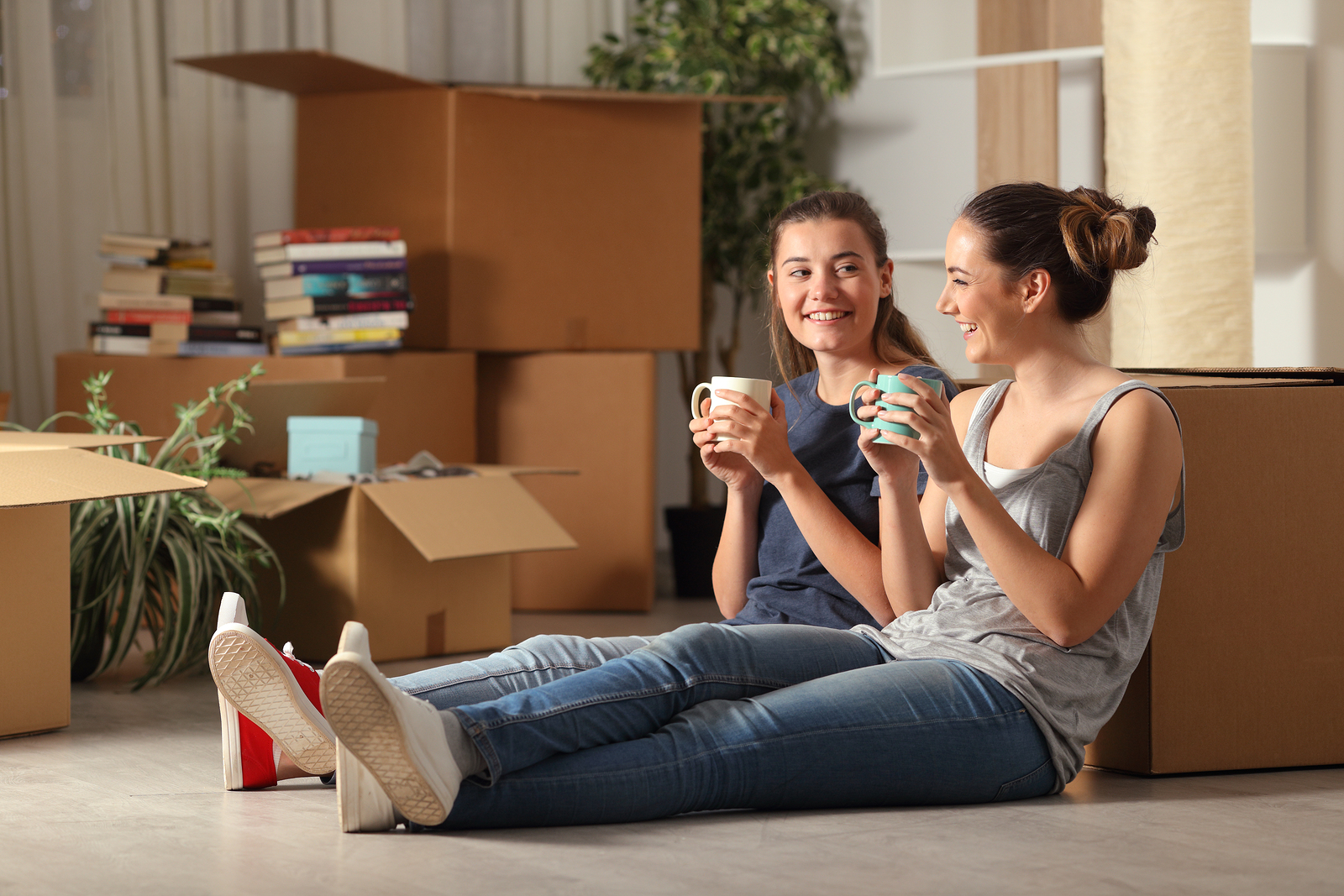 bigstock-two-happy-roommates-moving-hom-298309441.jpg