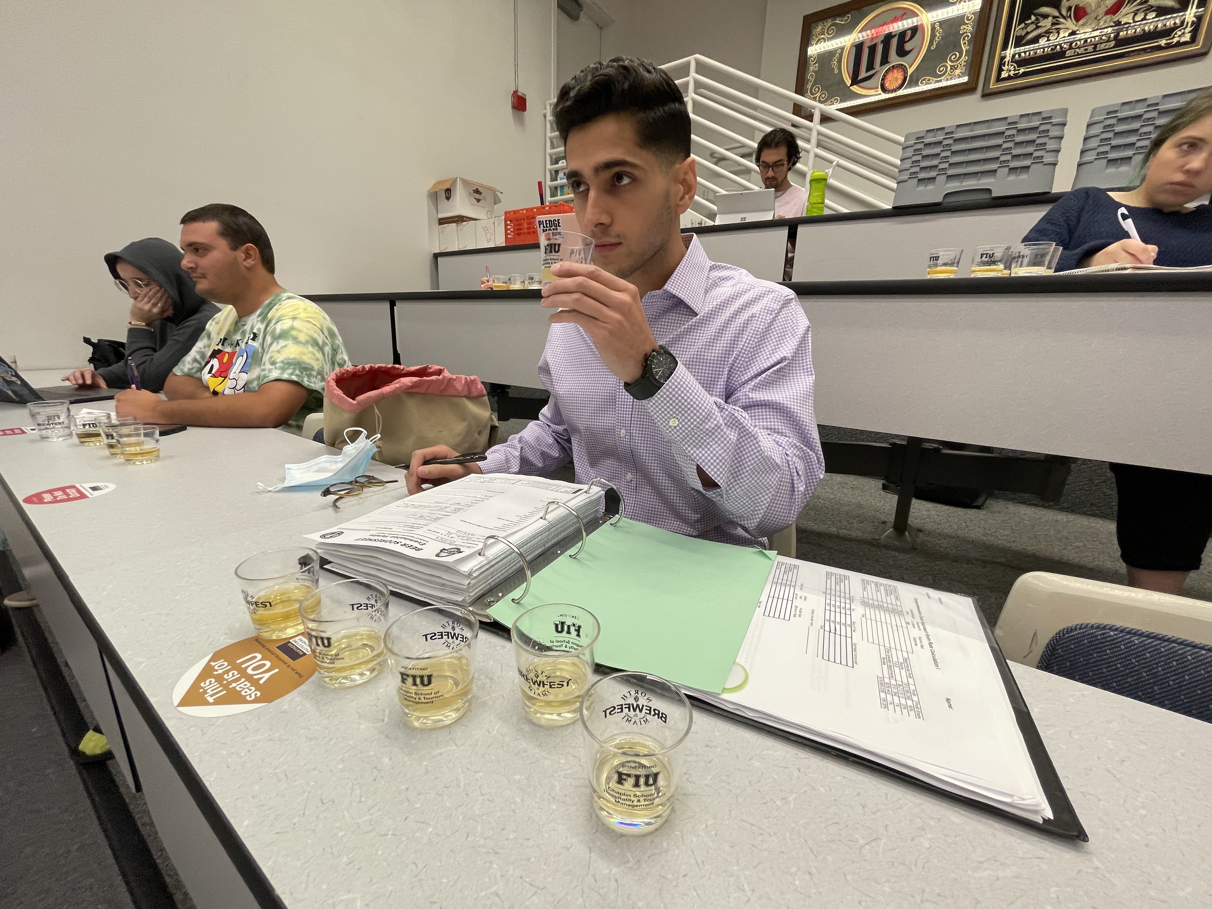 Hospitality Management grad student Emilio Santisteban smelling for skunk.