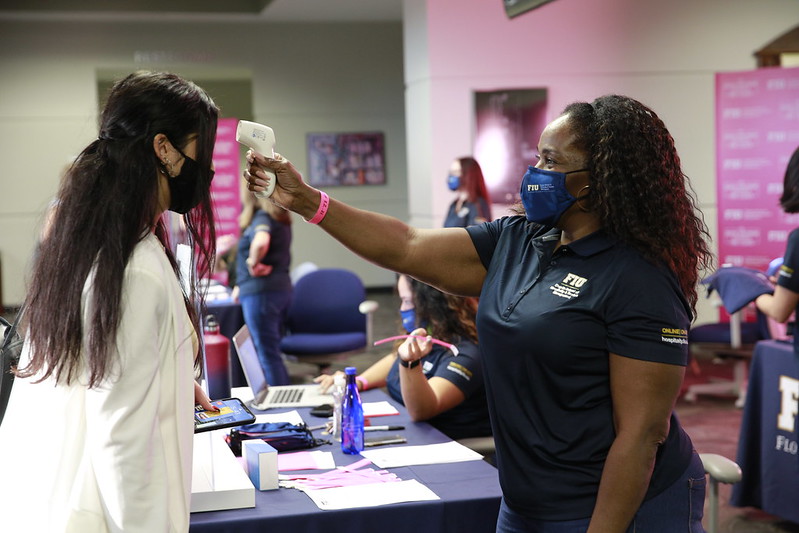 Students receive temperature checks after filling out P3 App upon arrival