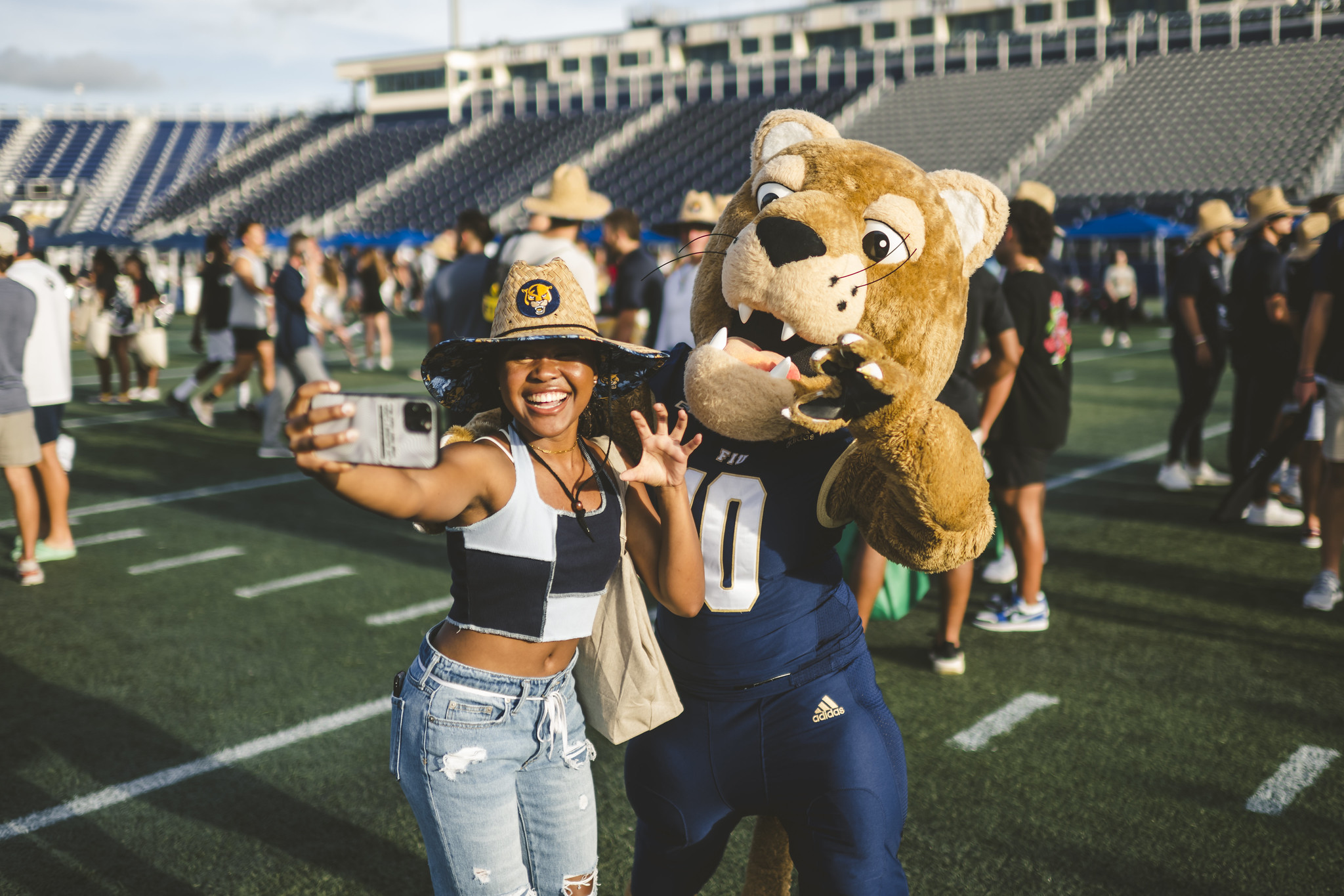 Panther wearing giveaway hat poses with Roary at F1RST NIGHT