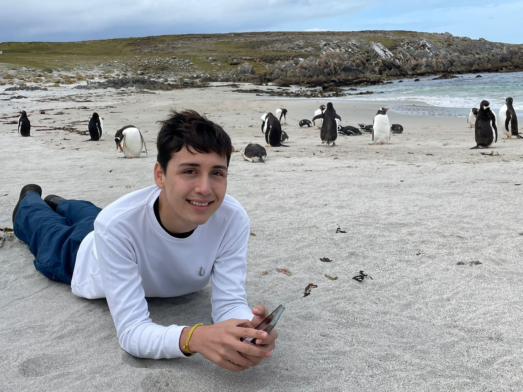 FIU Hospitality student Pedro Luis Velarde pictured with penguins in the Falkland Islands