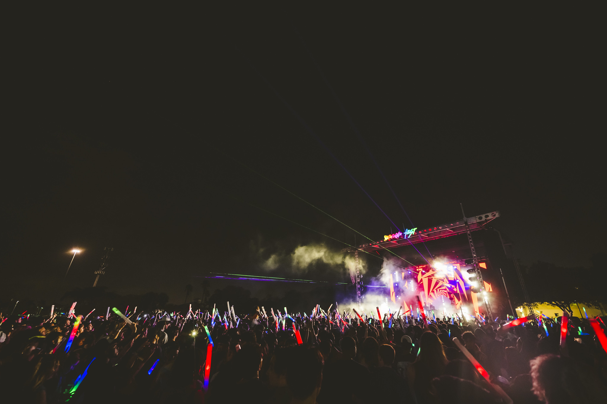 Wide-angle photo of crowd surrounding Summer Fest stage at night