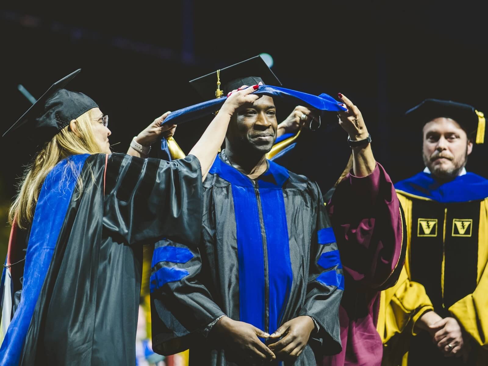 Graduate being awarded hood