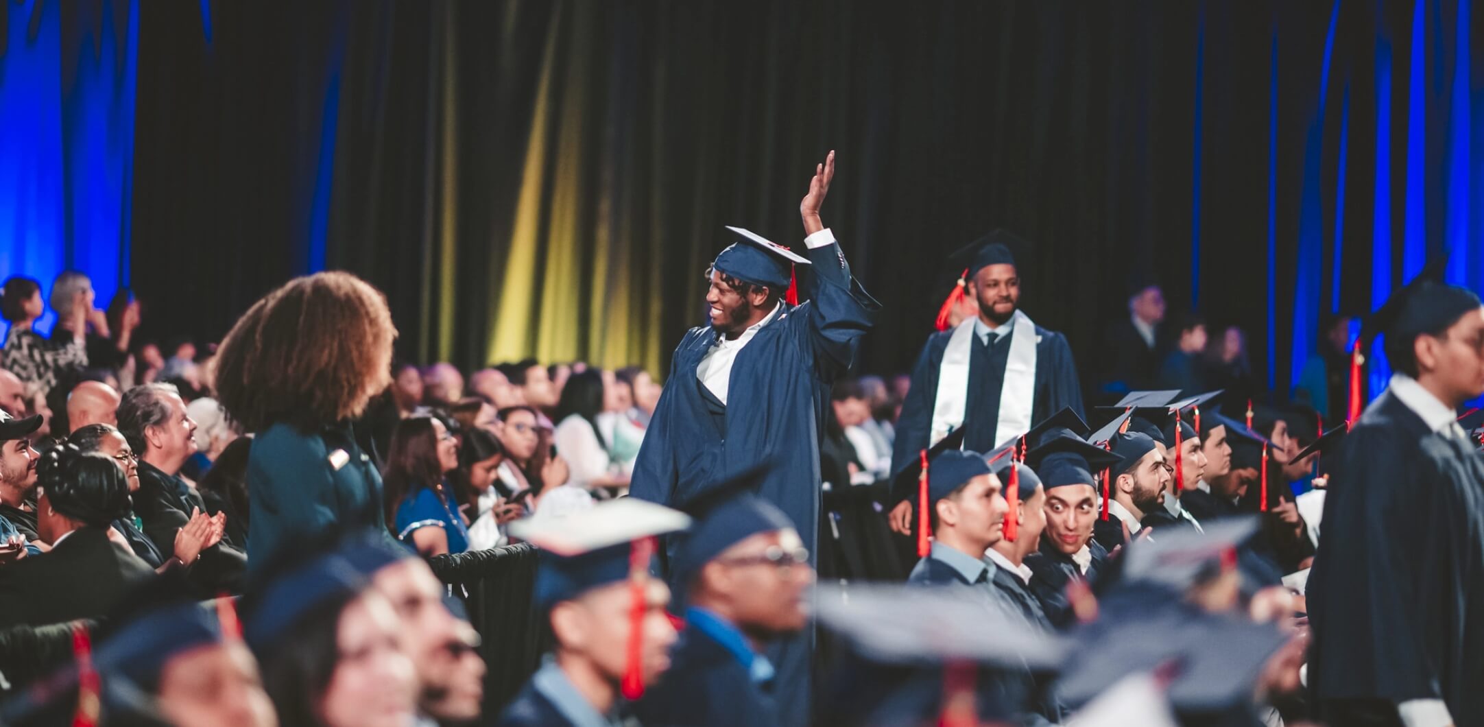 Graduate waving at audience