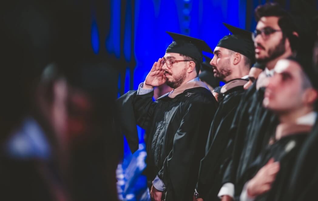 Graduate saluting