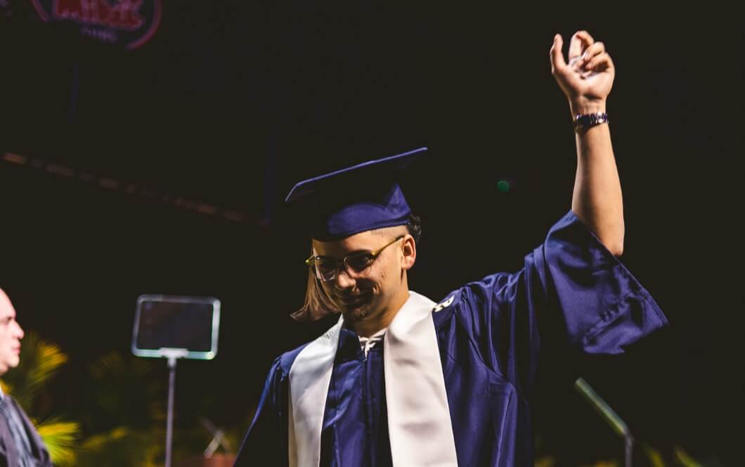 Graduate holding fist up