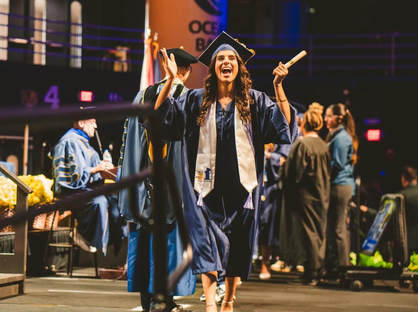 Graduate cheering with new diploma