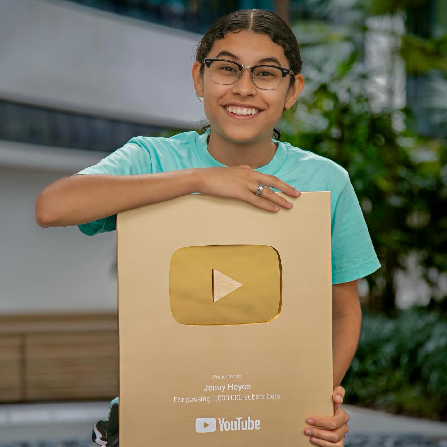 Jenny Hoyos with a plaque celebrating the moment when she gained more than 1 million subscribers on her YouTube channel