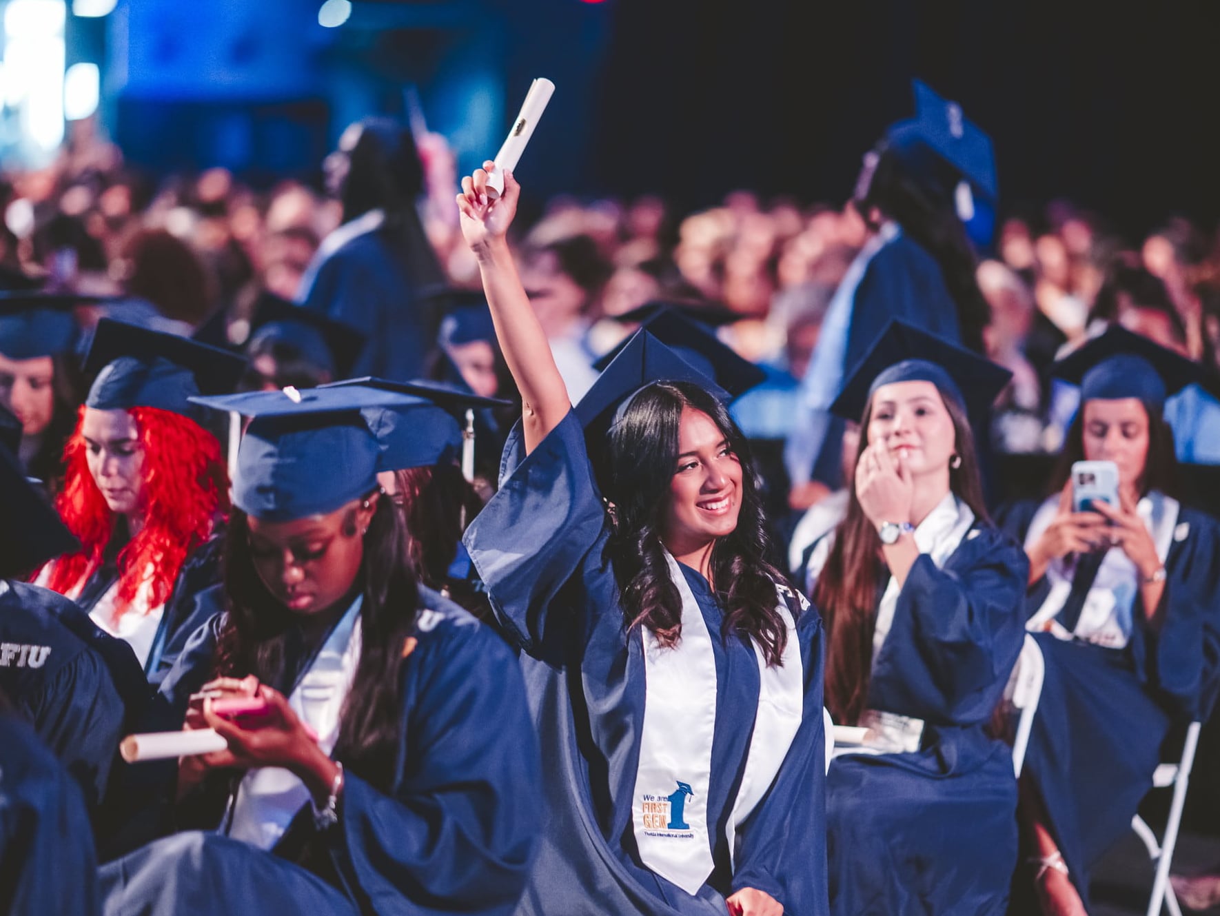 Graduate holding diploma up