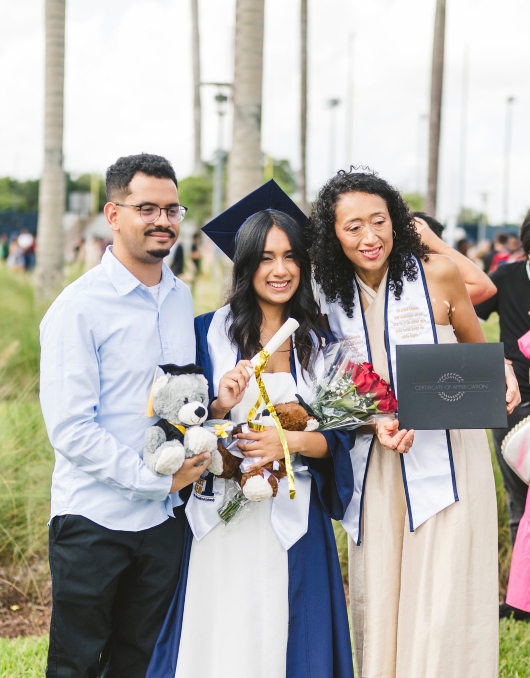 Graduate with her mother and family members