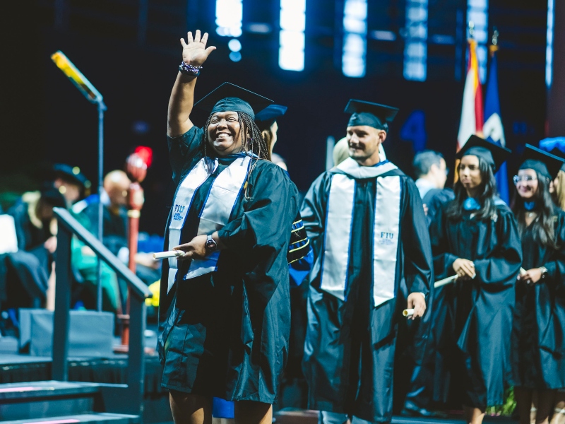 Graduate waving
