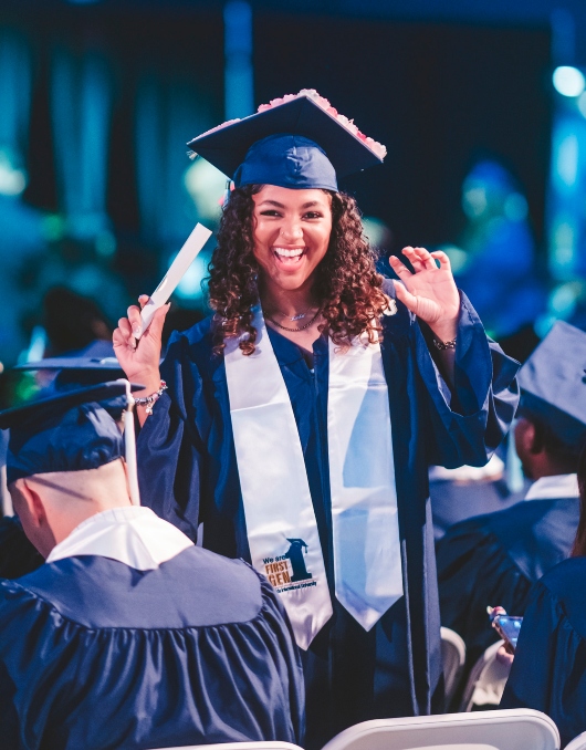 Graduate holding diploma