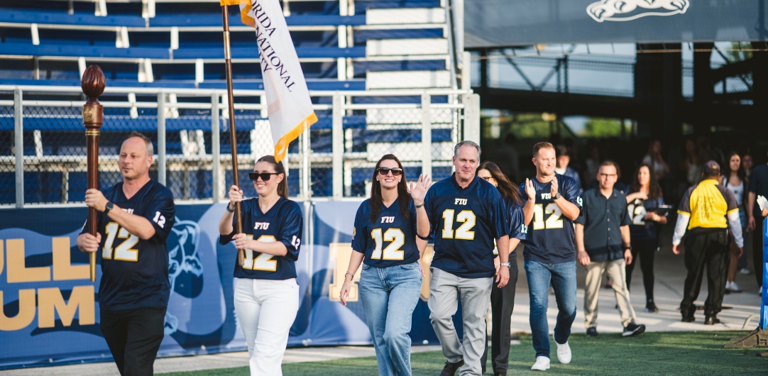 President Jeanette Nuñez, administrators and student leaders entering Pitbull Stadium in procession.