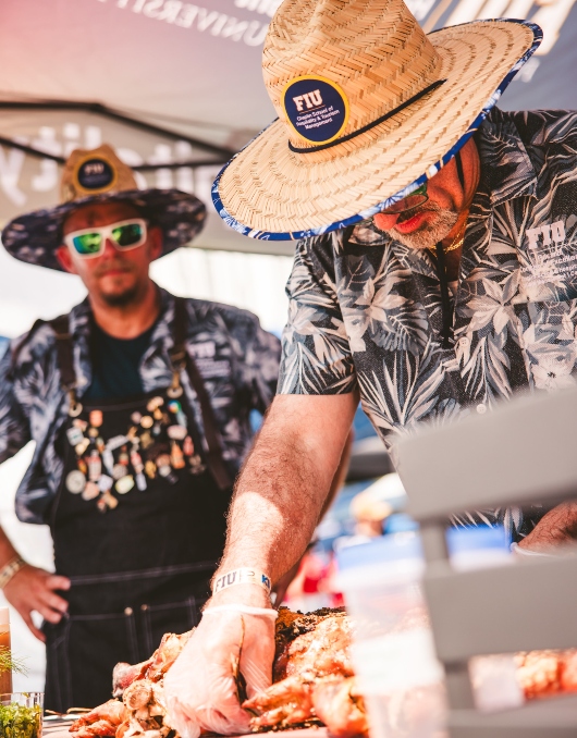 Herbert Wertheim College of Medicine team roasting pig