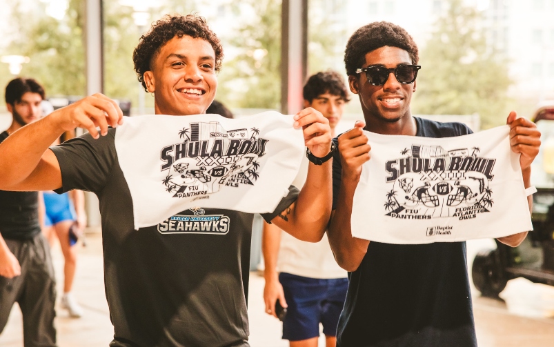 Students holding up Shula Bowl flag