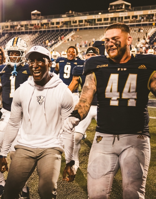 Football players and coaches celebrating