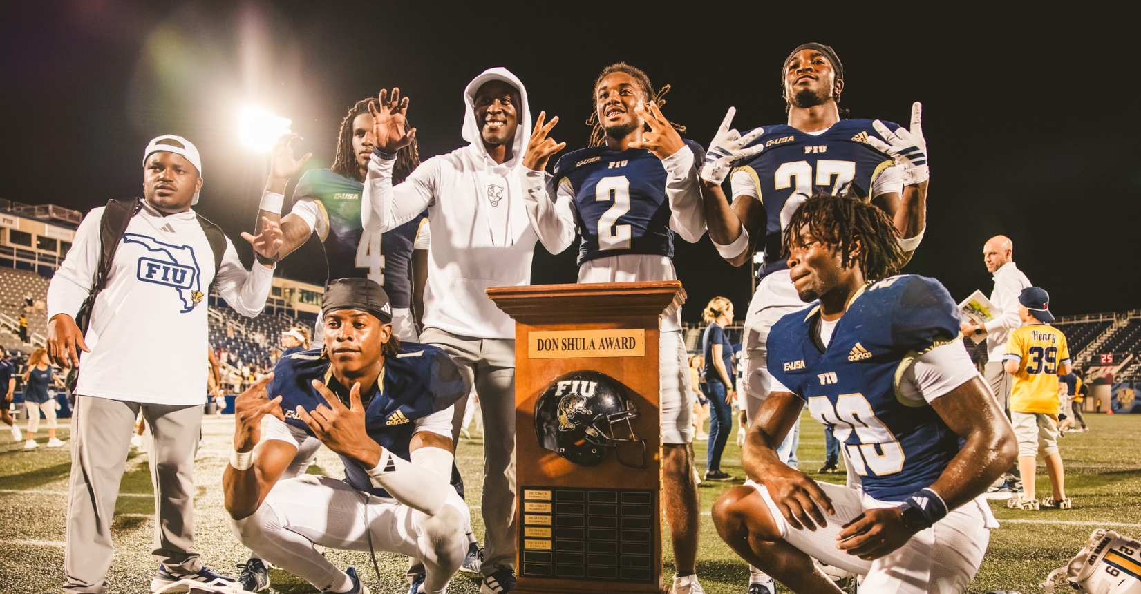 FIU football players celebrate with Shula Bowl award