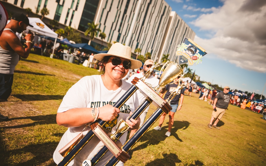 One of the Pig Roast competition winners holds up the trophy