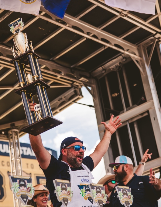 One of the Pig Roast competition winners holds up the trophy