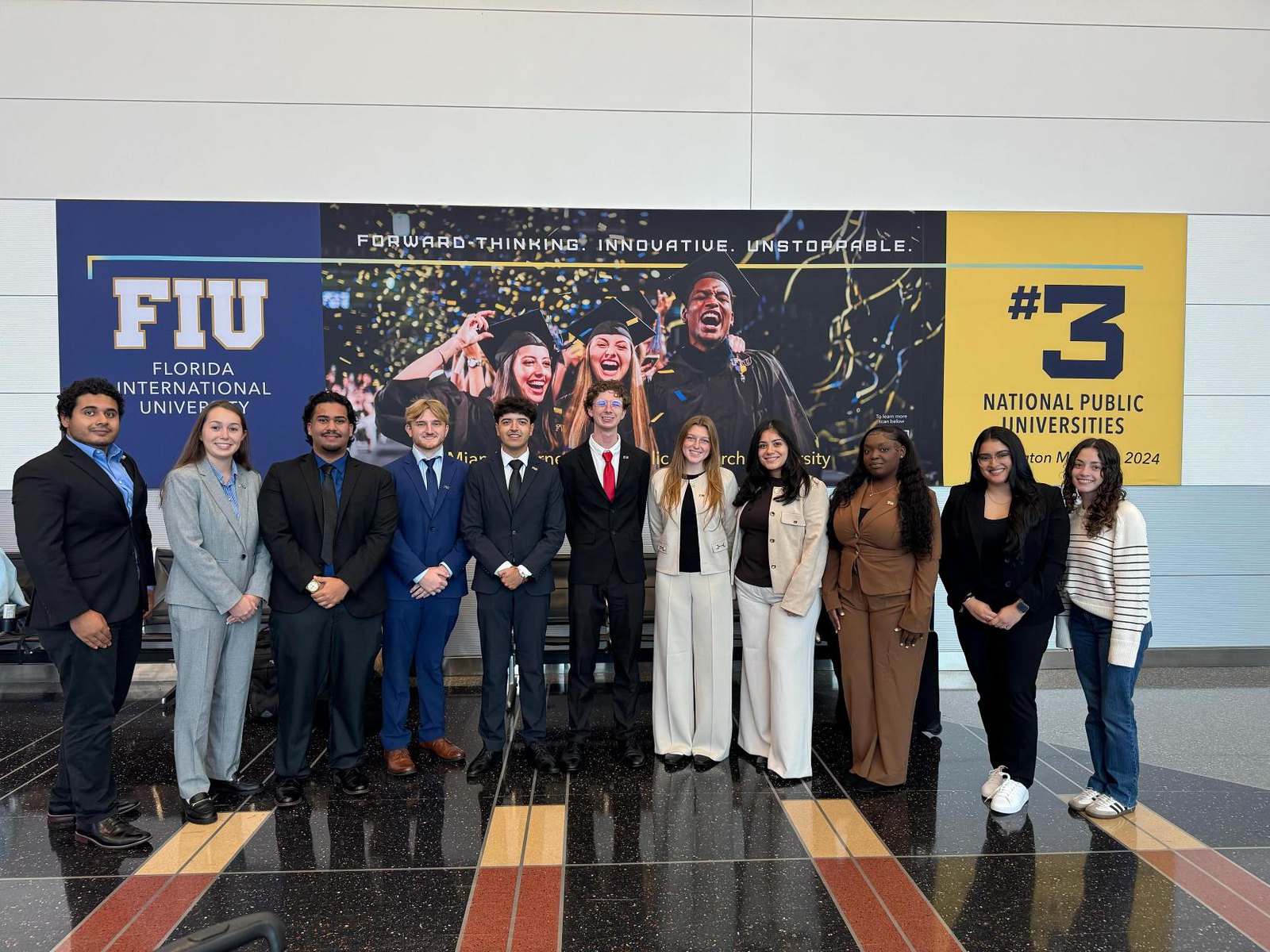 Students in front of FIU banner