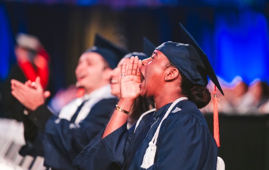 Graduate cheering during commencement
