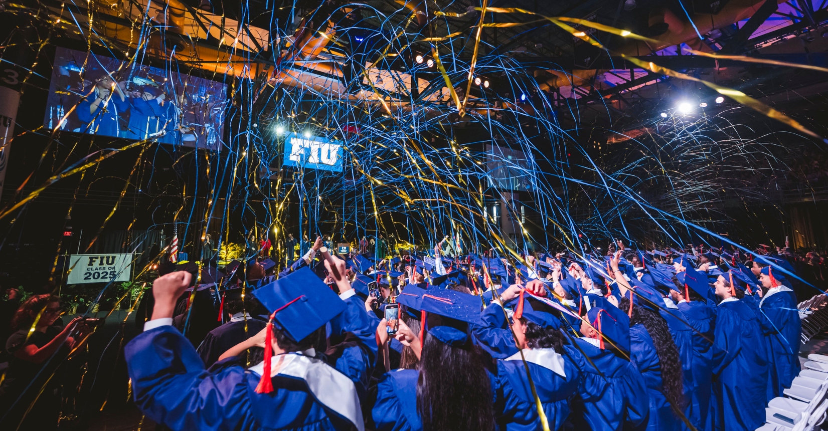 Gold and blue streamers showering the graduates in celebration