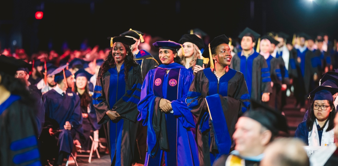 Students walking into commencement