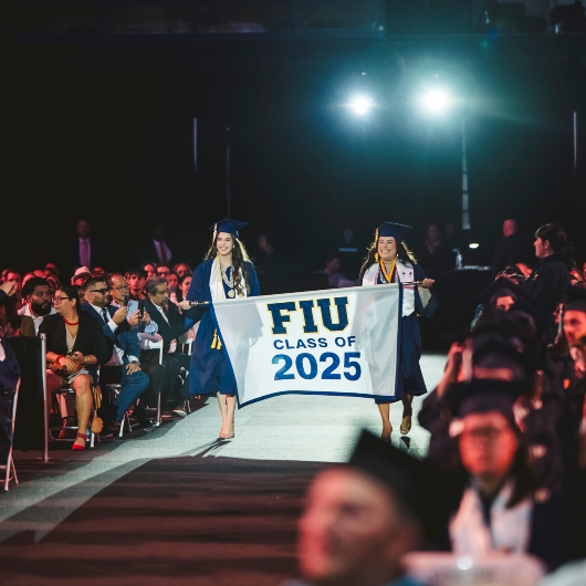 Student holding Class of 2025 banner