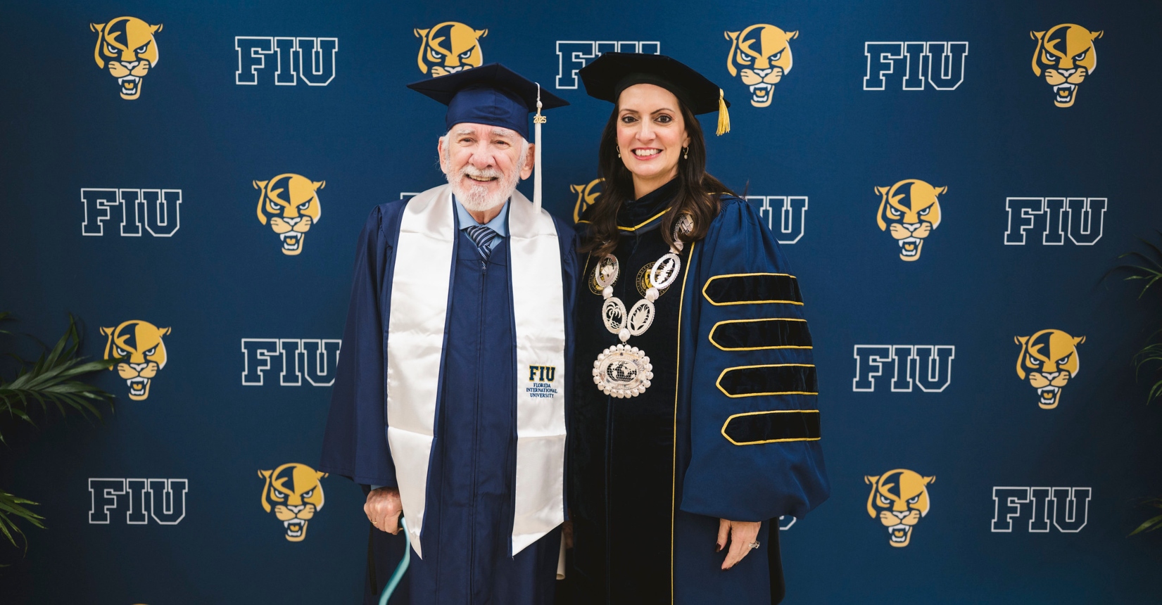 85-year-old graduate Roberto Fernandez with FIU President Jeanette M. Nuñez