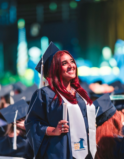 Student smiling with diploma