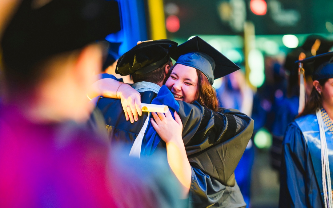 Graduate hugging professor in celebration