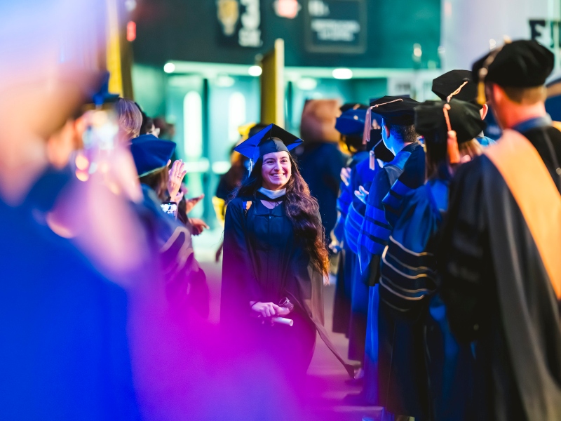 Graduate being greeted by faculty