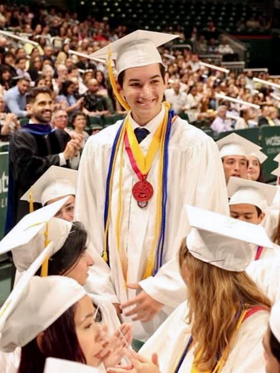 Sebastian Lopez in high school graduation cap and gown