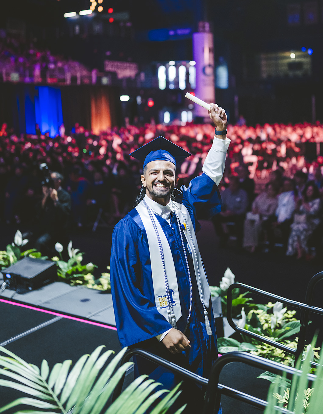 Graduate holding diploma in the air