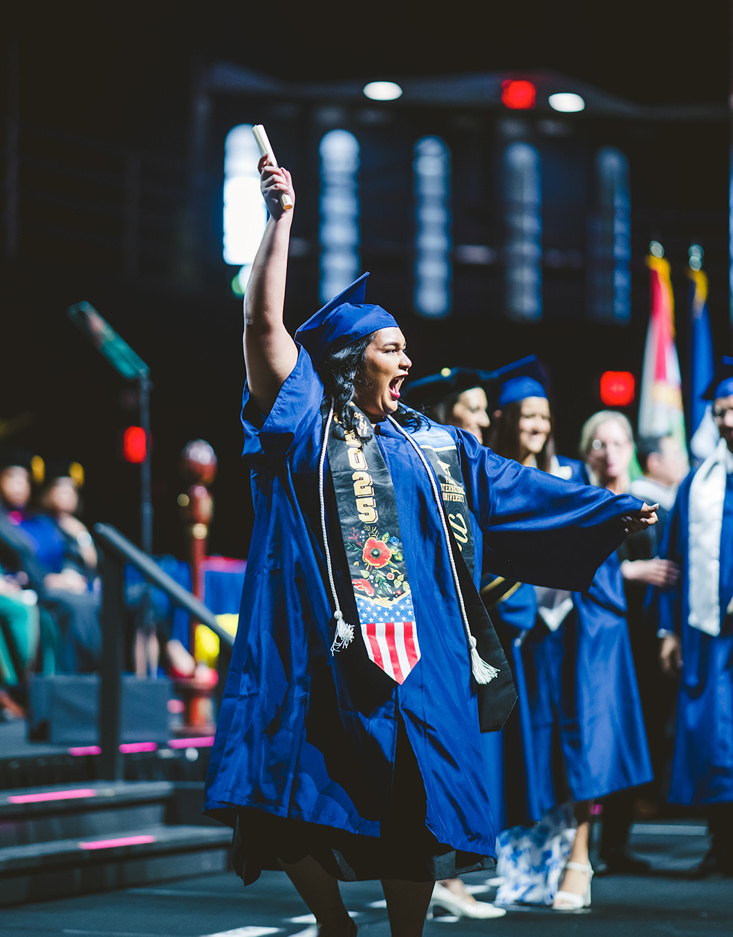 Graduate waving in the air