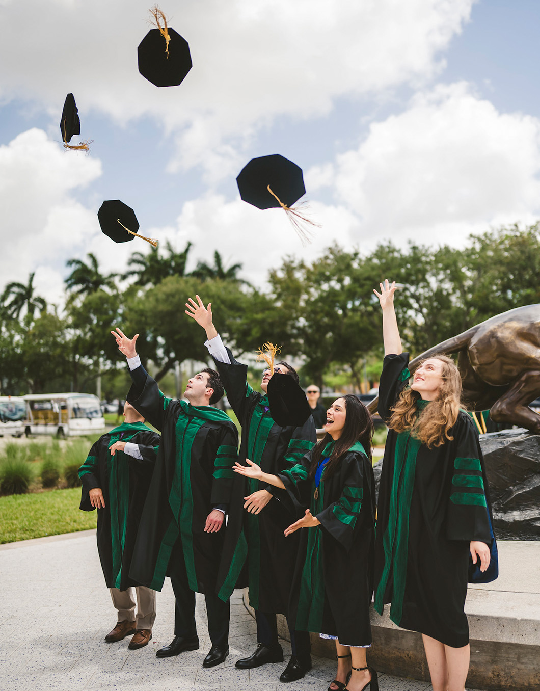 Graduate throwing their caps in the air
