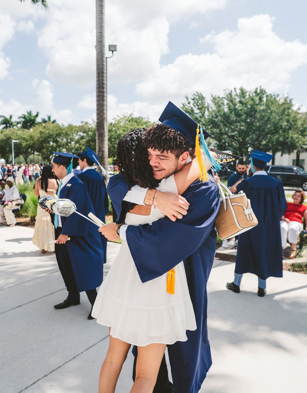 Graduate hugging a family member