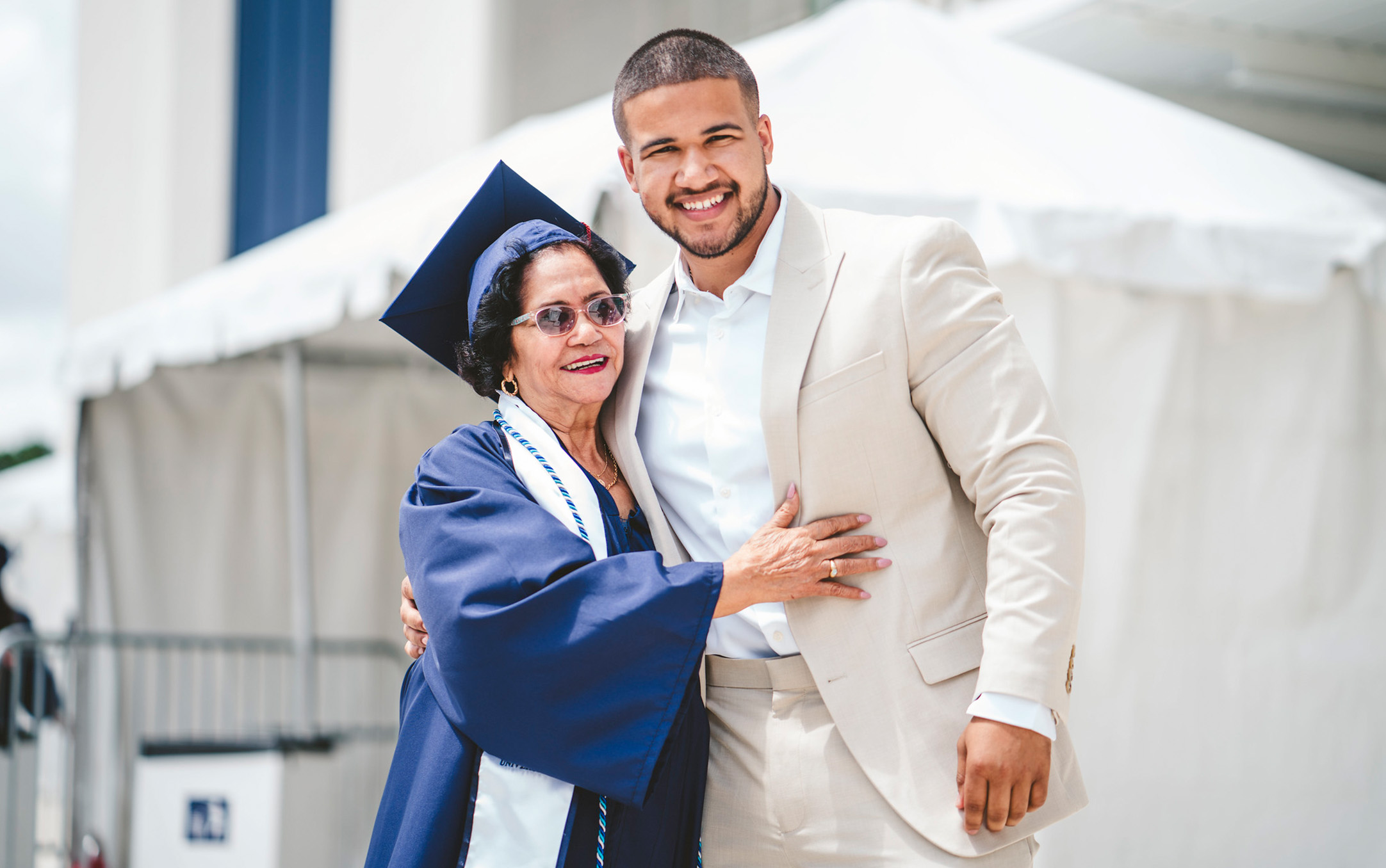 Graduate posing with family member