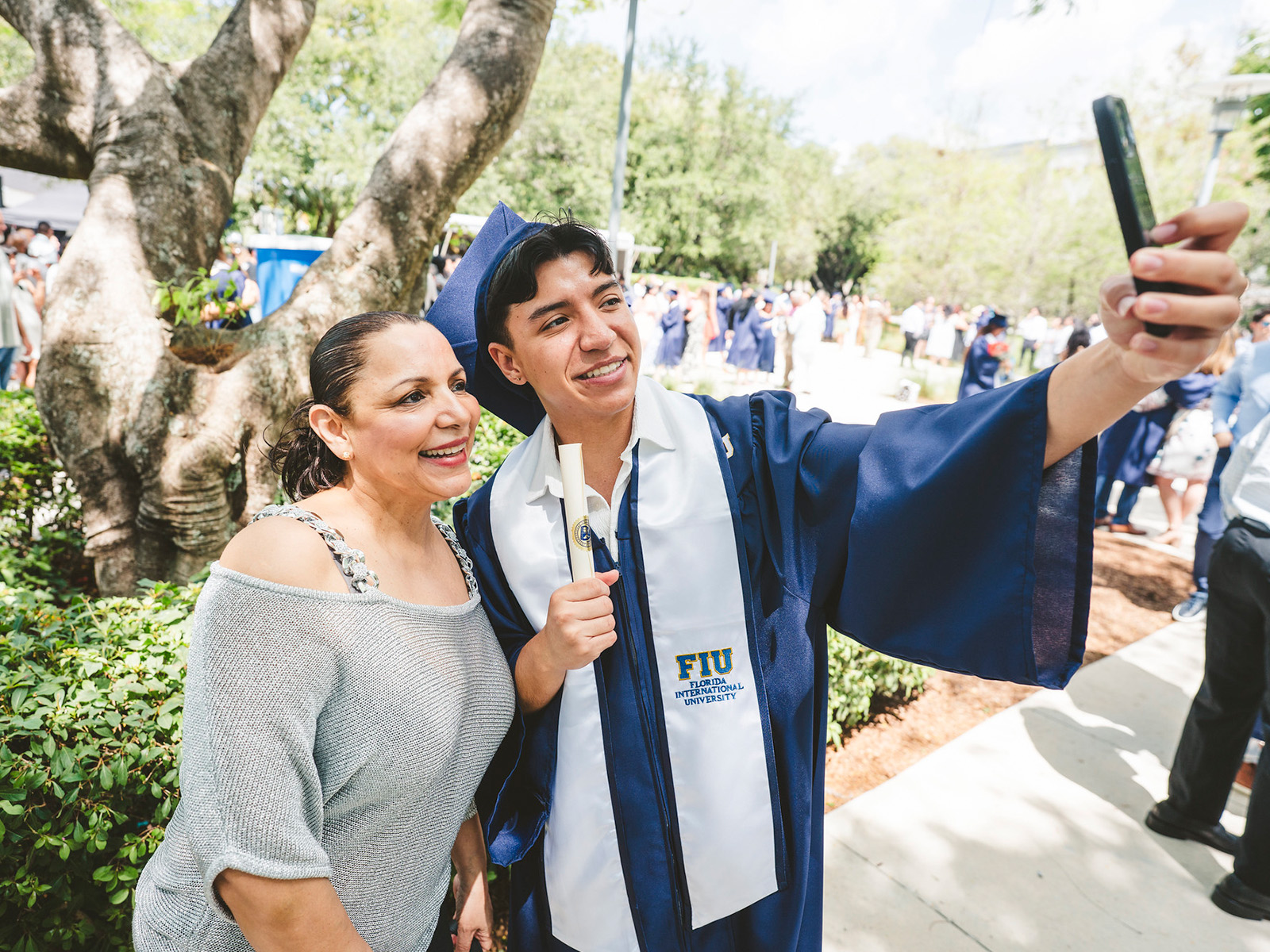 Graduating taking a selfie with a family member