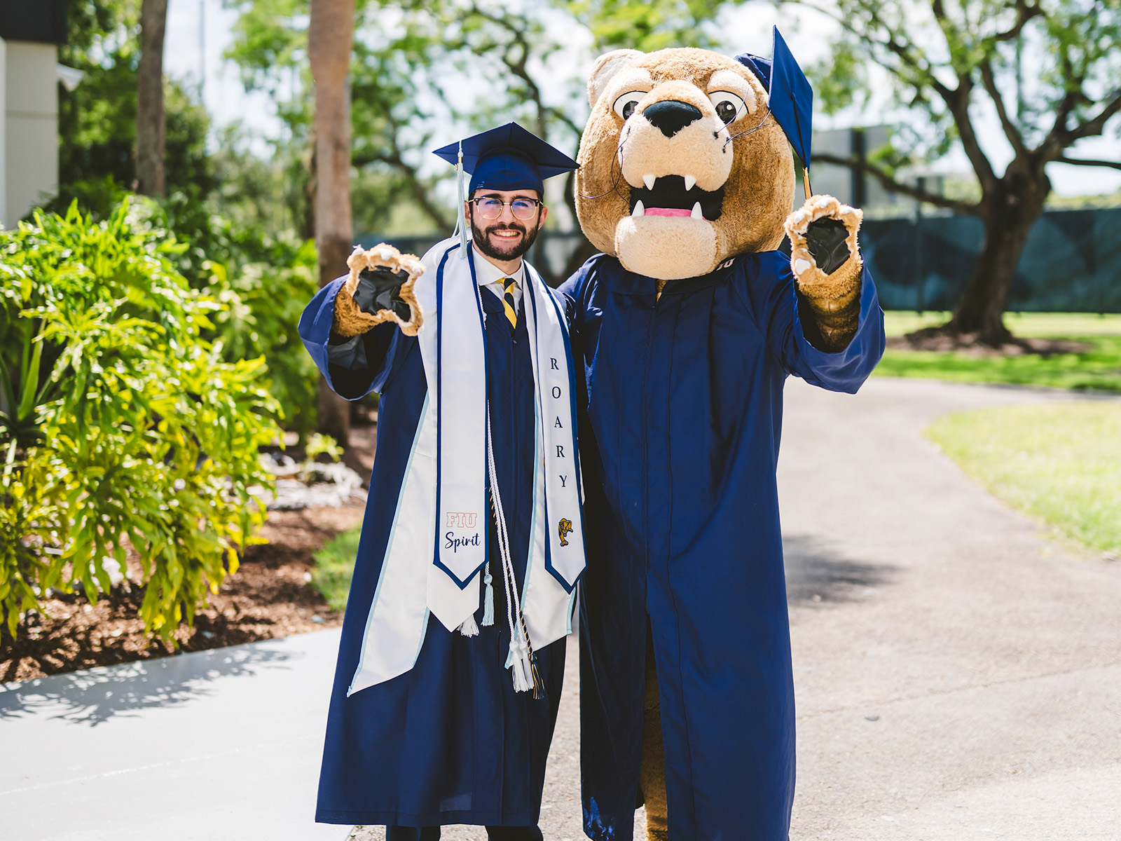 Graduting posing with family member