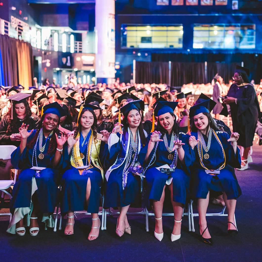 Graduates with their paws up