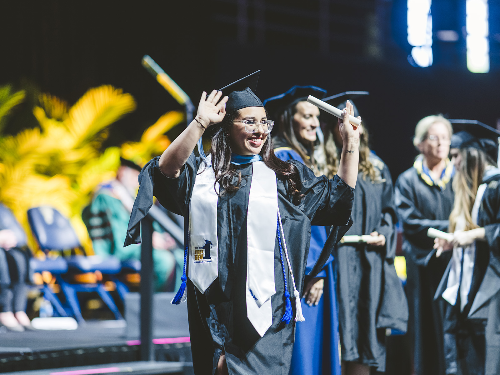 Graduate cheering as he walks off stage