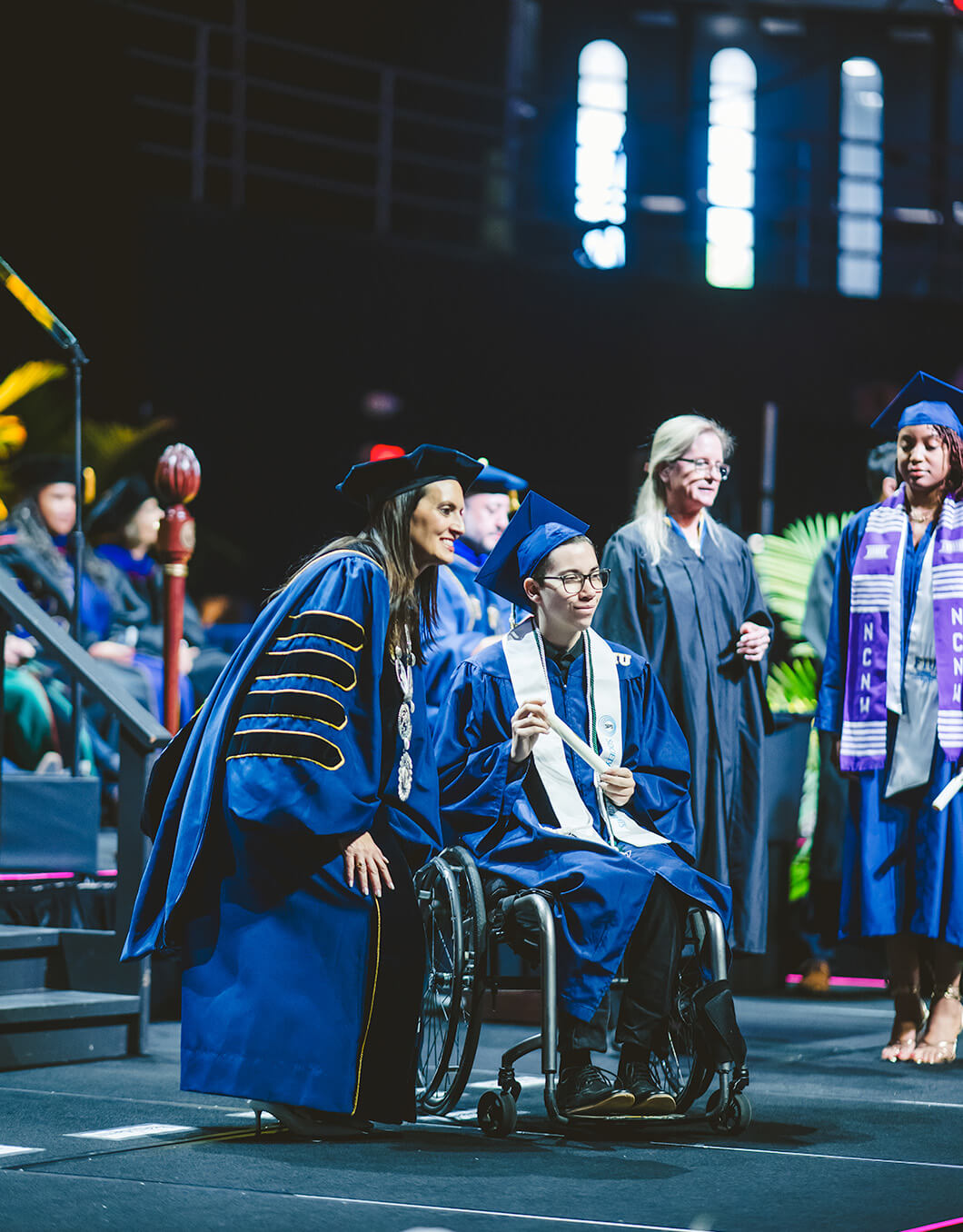 Graduate cheering on stage