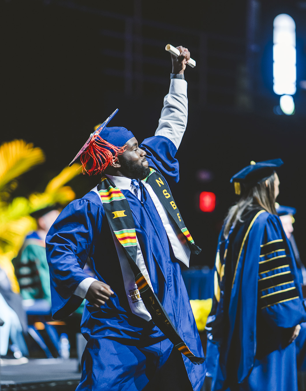 Graduate cheering into the crowd