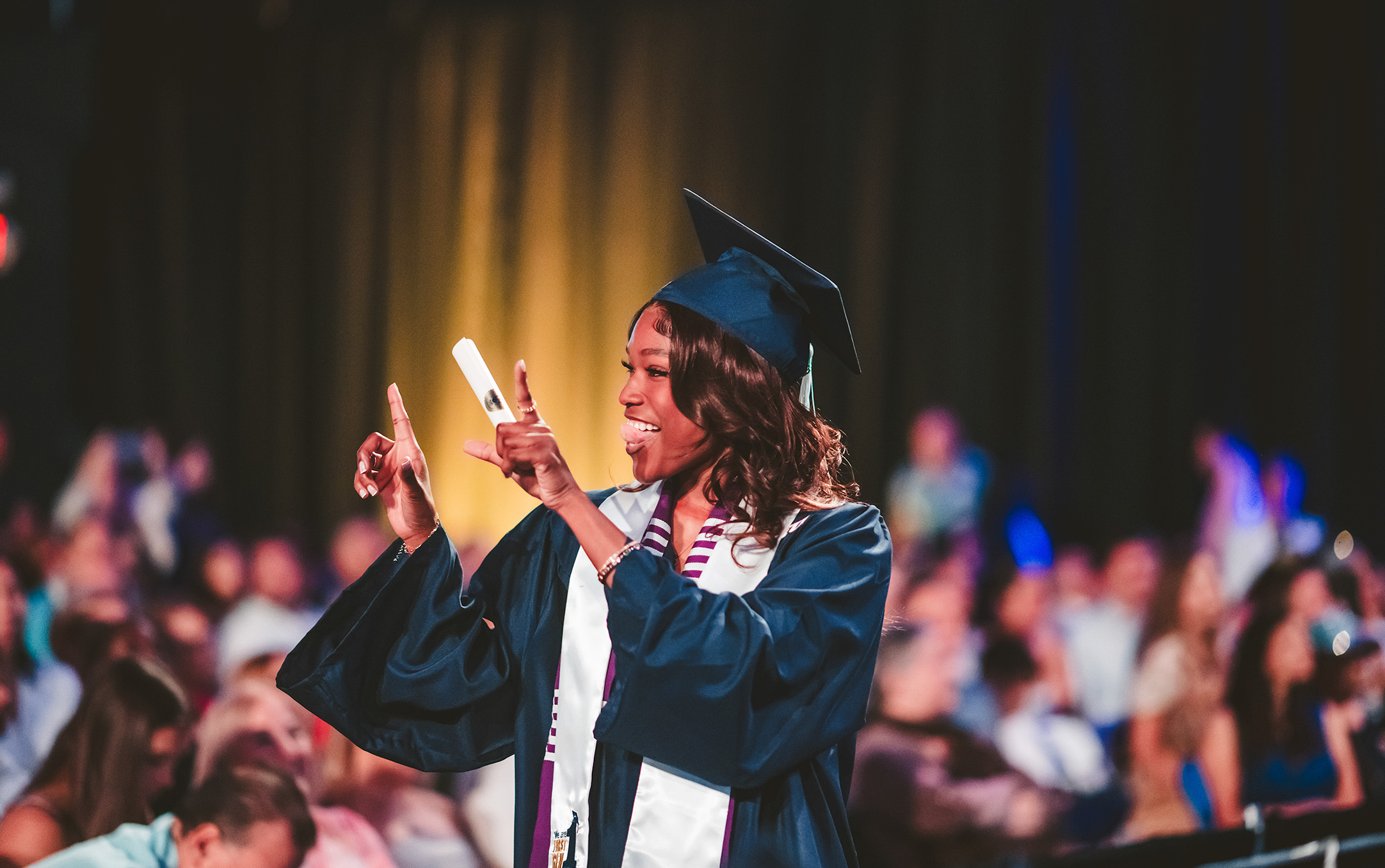 Graduate cheering with new diploma
