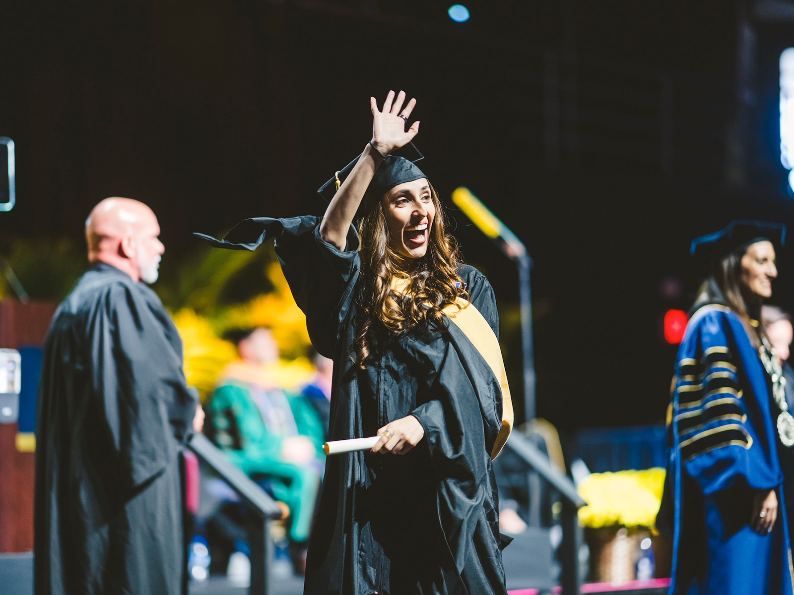 Graduate waving at audience
