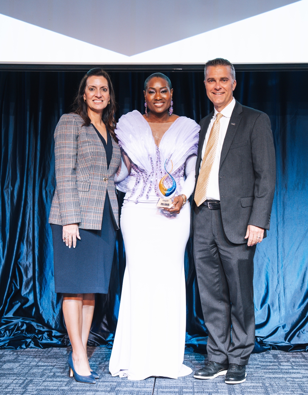 Tayna Lawrence with FIU President Jeanette Nuñez and Athletics Director Scott Carr