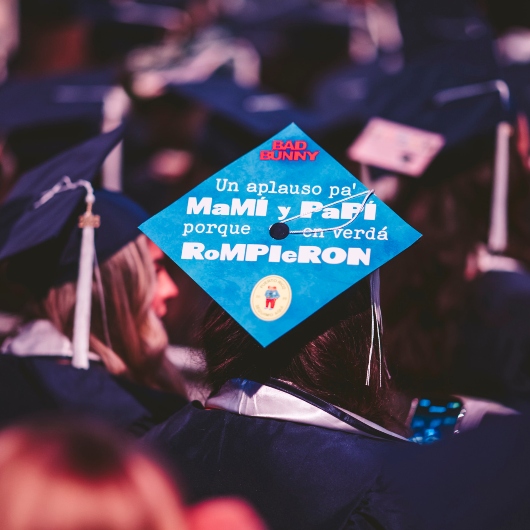 Graduate wearing decorated grad cap.